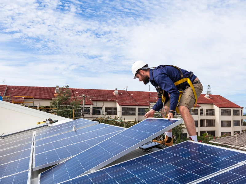 Solar installer carefully handling a panel to avoid solar panel damage during installation